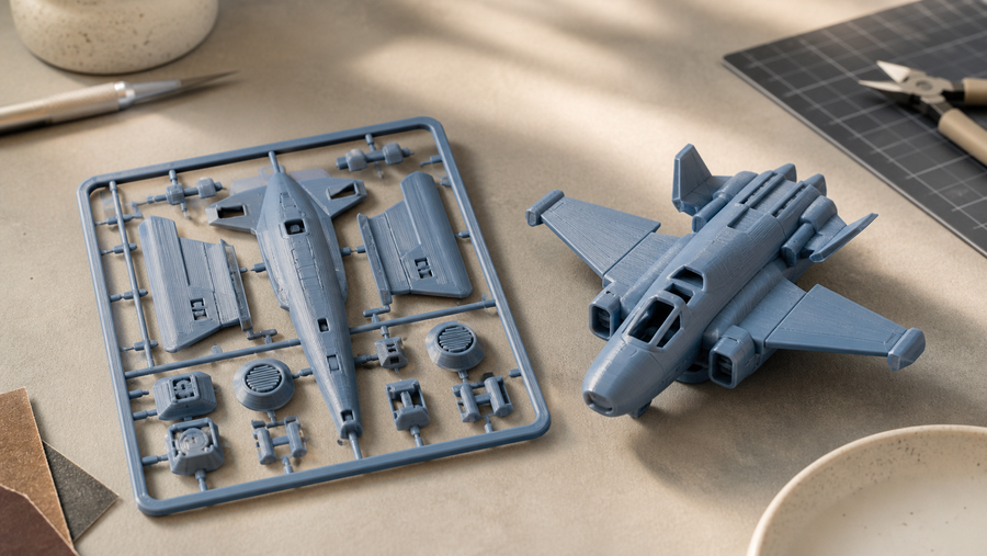 Generic aircraft-style 3D printed kit card beside its assembled miniature